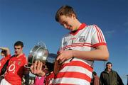 25 February 2012; Donal Casey, Cork, takes a close look at the Paul McGirr Cup after victory over Kildare. Senior All-Ireland Inter-County Football Vocational Schools Final, Kildare v Cork, Moyne-Templetuohy GAA Club, Tipperary. Picture credit: Pat Murphy / SPORTSFILE