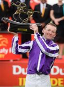 1 July 2017; Jockey Seamie Heffernan lifts the trophy after winning the Dubai Duty Free Irish Derby on Capri during the Dubai Duty Free Irish Derby Festival 2017 on Saturday at the Curragh in Kildare. Photo by Seb Daly/Sportsfile