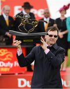 1 July 2017; Trainer Aidan O'Brien lifts the trophy after winning the Dubai Duty Free Irish Derby with Capri, ridden by Seamie Heffernan, during the Dubai Duty Free Irish Derby Festival 2017 on Saturday at the Curragh in Kildare. Photo by Seb Daly/Sportsfile
