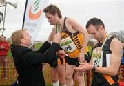 26 February 2012; Peter Dolan, Marketing Manager of Woodies DIY, presents the Gold medal to Eddie McGinley, Annadale Striders AC, Co. Antrim, after the Senior Men's race during the Woodie’s DIY AAI Inter Club Cross Country Championships of Ireland 2012. Santry Demesne, Santry, Dublin. Picture credit: Pat Murphy / SPORTSFILE