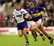 30 June 2002; Eoin McGrath, Waterford, in action against Paul Kelly, Tipperary. Waterford v Tipperary, Guinness Munster Hurling Final, Pairc Ui Chaoimh, Cork. Picture credit; Brendan Moran / SPORTSFILE