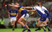 30 June 2002; John Carroll, Tipperary, in action against Waterford's Tom Feeney. Waterford v Tipperary, Guinness Munster Hurling Final, Pairc Ui Chaoimh, Cork. Picture credit; Ray McManus / SPORTSFILE