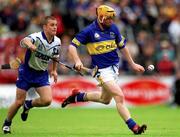 30 June 2002; Eamonn Corcoran, Tipperary, in action against Waterford's Eoin McGrath. Waterford v Tipperary, Guinness Munster Hurling Final, Pairc Ui Chaoimh, Cork. Picture credit; Ray McManus / SPORTSFILE