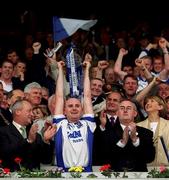 30 June 2002; Waterford captain Fergal Hartley lifts the cup in the presence of Christy Cooney, right, Chairman of the Munster Council and Michael Whelan of Guinness. Waterford v Tipperary, Guinness Munster Hurling Final, Pairc Ui Chaoimh, Cork. Picture credit; Ray McManus / SPORTSFILE