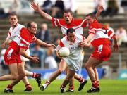 6 July 2002; Brian Dooher, Tyrone, in action against Derry players Fergal Crossan, Anthony Tohill and Ciaran McNally. Derry v Tyrone, Bank of Ireland All-Ireland Football Championship Qualifier Round 3, Casement Park, Belfast. Picture credit; Ray McManus / SPORTSFILE *EDI*