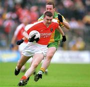 7 July 2002; Oisin McConville, Armagh, in action   against Raymond Sweeney, Donegal. Armagh v Donegal, Ulster Football Final, St Tighearnachs Park, Clones, Co. Monaghan. Picture credit; David Maher / SPORTSFILE