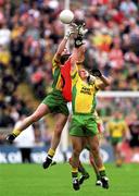 7 July 2002; Donegal pair, John Gildea and Kevin   Cassidy, (front) field the ball with Barry O'Hagan, Armagh. Armagh v Donegal, Ulster Football Final, St Tighearnachs Park, Clones, Co. Monaghan. Picture credit; Damien Eagers / SPORTSFILE