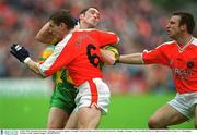 8 July 2002; Brendan Devenney, Donegal, in action against Armagh's Enda McNulty and Kieran McGeeney (6). Armagh v Donegal, Ulster Football Final, St Tighearnachs Park, Clones, Co. Monaghan. Picture credit; Damien Eagers / SPORTSFILE