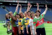 9 July 2002; Pictured at the announcement of the continued sponsorship of the Ladies Football Championship by TG4 are  Inter county players from l-r; Anna Connolly, Laois, with the Cup, Grainne Ni Laoithe, Kerry, Martina Farrell, Dublin, Niamh Kindlon, Monaghan, Noelle Comyn, Clare, Elaine Duffy, Meath, Mary Beades, Roscommon, Michaela Doherty, Tyrone and Christina Heffernan, Mayo. Croke Park, Dublin. Picture credit; Ray McManus / SPORTSFILE