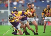 7 July 2002; Darren Stamp, Wexford, clears the ball under pressure from Charlie Carter, Kilkenny, with the assistance of team-mate Colm Kehoe. Wexford v Kilkenny, Guinness Leinster Senior Hurling Championship Final, Croke Park, Dublin. Picture credit; Brian Lawless / SPORTSFILE