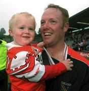 8 July 2002; Armagh's Brendan Tierney pictured with his son Conor after the game. Armagh v Donegal, Ulster Football Final, St Tighearnachs Park, Clones, Co. Monaghan. Picture credit; David Maher / SPORTSFILE