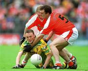 8 July 2002; Colm McFadden, Donegal, in action against Aidan O'Rourke, Armagh. Armagh v Donegal, Ulster Football Final, St Tighearnachs Park, Clones, Co. Monaghan. Picture credit; David Maher / SPORTSFILE