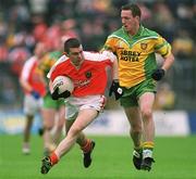 8 July 2002; Oisin McConville, Armagh, in action against Raymond Sweeney, Donegal. Armagh v Donegal, Ulster Football Final, St Tighearnachs Park, Clones, Co. Monaghan. Picture credit; David Maher / SPORTSFILE