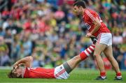 2 July 2017; Ian Maguire of Cork is helped with cramp by team-mate Stephen Cronin of Cork during the Munster GAA Football Senior Championship Final match between Kerry and Cork at Fitzgerald Stadium in Killarney, Co Kerry. Photo by Brendan Moran/Sportsfile