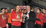 28 February 2012; IT Carlow captain James Scallan is presented with the Premier Division cup by FAI chief executive John Delaney after the game. Umbro CUFL Premier Division Final, IT Carlow v Athlone IT, Frank Cooke Park, Glasnevin, Dublin. Picture credit: Barry Cregg / SPORTSFILE