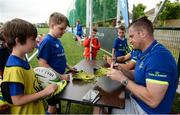 5 July 2017; Jamie Heaslip and Jamison Gibson-Park of Leinster Rugby came out to the Bank of Ireland Summer Camp to meet up with some local young rugby talent in Terenure College RFC. Pictured is Leinster's Jamie Healsip sign a boot for young Simon Eagan, from Portobello, Dublin. Terenure College RFC, Terenure, Dublin. Photo by Seb Daly/Sportsfile