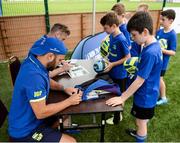 5 July 2017; Jamie Heaslip and Jamison Gibson-Park of Leinster Rugby came out to the Bank of Ireland Summer Camp to meet up with some local young rugby talent in Terenure College RFC. Pictured are the Leinster players signing items for the attendees. Terenure College RFC, Terenure, Dublin. Photo by Seb Daly/Sportsfile