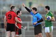 4 March 2012; Conor Laverty, Down, restrained by team-mate Kalum King, 9, is ordered to leave the pitch by referee Damian Brazil after he received a yellow and subsequent red card. Soon after Laverty was ordered to return to the pitch after receiving only one yellow card. Allianz Football League, Division 1, Round 3, Down v Kerry, Pairc Esler, Newry, Co. Down. Picture credit: Stephen McCarthy / SPORTSFILE