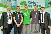 2 March 2012; Medallists in the Men's 100m breaststroke, from left, Johnny P Quinn, silver, Dolphin SC, Nicholas Quinn, gold, Castlebar SC, and Dan Sweeney, bronze, Sunday's Well SC, with Wally Clarke, left, President, Swim Ireland and Gary Keegan, Irish Institute of Sport, during the Irish Long Course National Swimming Championships/Olympic Trials. National Aquatic Centre, Abbotstown, Dublin. Picture credit: Brendan Moran / SPORTSFILE