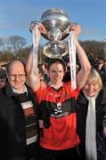 3 March 2012; UCC captain Shane Bourke lifts the cup, alongside his father Paddy, left, and his mother Teresa, after victory over CIT. Irish Daily Mail Fitzgibbon Cup Final, University College Cork v Cork Institute of Technology, Mardyke Arena, Cork. Picture credit: Diarmuid Greene / SPORTSFILE