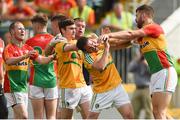 8 July 2017; Daniel St. Ledger of Carlow strikes Brendan Gallagher of Leitrim during the GAA Football All-Ireland Senior Championship Round 2B match between Carlow and Leitrim at Netwatch Cullen Park in Co Carlow. Photo by Barry Cregg/Sportsfile