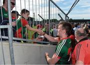 8 July 2017; Cillian O'Connor of Mayo exchanges a handshake with Jake Hyland, aged 7, from Tubbercurry, Co. Mayo, after the GAA Football All-Ireland Senior Championship Round 3A match between Clare and Mayo at Cusack Park in Ennis, Co Clare. Photo by Diarmuid Greene/Sportsfile