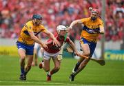 9 July 2017; Luke Meade of Cork gets the sliotar away under pressure from David McInerney, left, and David Fitzgerald of Clare during the Munster GAA Hurling Senior Championship Final match between Clare and Cork at Semple Stadium in Thurles, Co Tipperary. Photo by Brendan Moran/Sportsfile