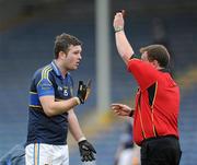 11 March 2012; Referee Michael Meade shows Tipperary's Barry Grogan the red card. Allianz Football League Division 4, Round 4, Tipperary v Cavan, Semple Stadium, Thurles, Co. Tipperary. Picture credit: Brian Lawless / SPORTSFILE