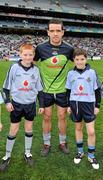11 March 2012; Mascots Fiachra Potts, left, and John Foley, from the Na Fianna GAA Club, with Dublin captain Ger Brennan before the game. Allianz Football League Division 1, Round 4, Dublin v Armagh, Croke Park, Dublin. Picture credit: Ray McManus / SPORTSFILE