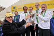 10 March 2012; The St. MacDara's CC, Co. Dublin, Nadia Power, team, from left to right, Cara Dawson, Sarah Lahiff, and Carla Sweeney are presented with their trophy by Michael Hunt, President of the Irish Schools' Athletics Association, after winning the Junior Girls 2000m race at the Aviva All-Ireland Schools' Cross Country 2012. St Mary’s College, Galway. Picture credit: Diarmuid Greene / SPORTSFILE