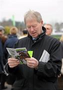 13 March 2012; Former RTE Gaelic Games Commentator Micheal O Muircheartaigh studies his racecard at the  Cheltenham Festival. Cheltenham Racing Festival, Prestbury Park, Cheltenham, England. Picture credit: Matt Browne / SPORTSFILE