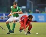 13 March 2012; Yong Nam Lee, Korea, in action against David Ames, Ireland. Men’s 2012 Olympic Qualifying Tournament, Ireland v Korea. National Hockey Stadium, UCD, Belfield, Dublin. Picture credit: Barry Cregg / SPORTSFILE