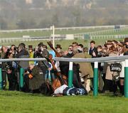 14 March 2012; Jockey Richard Johnson is unseated by his mount Wishful Thinking as they crash into a number of photographers and trackside personnel after they had jumped the 'last first time round' during the sportingbet.com Queen Mother Champion Steeple Chase. Cheltenham Racing Festival, Prestbury Park, Cheltenham, England. Picture credit: Brendan Moran / SPORTSFILE