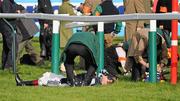 14 March 2012; Jockey Richard Johnson after he was unseated by his mount Wishful Thinking and crashed into a number of photographers and trackside personnel after they had jumped the 'last first time round' during the sportingbet.com Queen Mother Champion Steeple Chase. Cheltenham Racing Festival, Prestbury Park, Cheltenham, England. Picture credit: Brendan Moran / SPORTSFILE