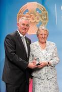 16 March 2012; Sheila Spillane, Killeagh Camogie Club, is presented with her GAA President's Award for 2012 by Uachtarán Cumann Lúthchleas Gael Criostóir Ó Cuana, at the GAA Presidents Awards 2012. Sheila has given a lifetime of service to the club and since 1973 more than 1000 girls from the locality have had the opportunity to play the game. A testament to the current president of the club is that eight years ago she spent her winnings from the GAA club lotto on a defibrillator machine. GAA Presidents Awards 2012, Croke Park, Dublin. Picture credit: Brian Lawless / SPORTSFILE