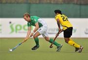 17 March 2012; Michael Watt, Ireland, in action against Singh Charun Singh Baljit, Malaysia. Men’s 2012 Olympic Qualifying Tournament, Ireland v Malaysia, National Hockey Stadium, UCD, Belfield, Dublin. Picture credit: Barry Cregg / SPORTSFILE