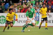 17 March 2012; William Geoffrey McCabe, Ireland, in action against Fitri Mohd Saari, Malaysia. Men’s 2012 Olympic Qualifying Tournament, Ireland v Malaysia, National Hockey Stadium, UCD, Belfield, Dublin. Picture credit: Barry Cregg / SPORTSFILE