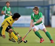 17 March 2012; GIan Sloan, Ireland, in action against Fitri Mohd Saari, Malaysia. Men’s 2012 Olympic Qualifying Tournament, Ireland v Malaysia, National Hockey Stadium, UCD, Belfield, Dublin. Picture credit: Barry Cregg / SPORTSFILE