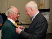 9 March 2012; Dr. Pat Hickey, President of the OCI, presents Denis Sugure, rowing, left, a member of the 1948 Olympic Team, with his Olympic Medal of Honour. Farmleigh House, Phoenix Park, Dublin 15. Picture credit: Ray McManus / SPORTSFILE