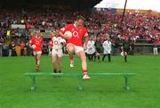 14 July 2002; Cork captain Colin Corkery jumps the bench before the team photograph before the Bank of Ireland Munster Senior Football Championship Final match between Cork and Tipperary at Semple Stadium in Thurles, Tipperary. Photo by Brendan Moran/Sportsfile
