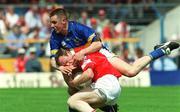 14 July 2002; Philip Clifford of Cork in action against Niall Fitzgerald of Tipperary during the Bank of Ireland Munster Senior Football Championship Final match between Cork and Tipperary at Semple Stadium in Thurles, Tipperary. Photo by Pat Murphy/Sportsfile