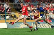 14 July 2002; Brendan Ger O'Sullivan of Cork scores his and side's second goal despite Niall Fitzgerald of Tipperary during the Bank of Ireland Munster Senior Football Championship Final match between Cork and Tipperary at Semple Stadium in Thurles, Tipperary. Photo by Brendan Moran/Sportsfile