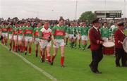 13 July 2002; The Mayo and Limerick teams in the pre-match parade prior to the Bank of Ireland All-Ireland Senior Football Championship Qualifier Round 3 match between Mayo and Limerick at Dr Hyde Park in Roscommon. Photo by Damien Eagers/Sportsfile