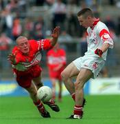 7 July 2002; Martin Hughes of Tyrone in action against Patsy Bradley of Derry during the Ulster Minor Football Championship Final between Derry and Tyrone at St Tiernach’s Park in Clones, Monaghan. Photo by Ray McManus/Sportsfile