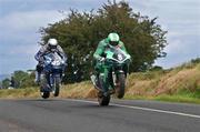 20 July 2002; Richard Britton, 8, is followed by Martin Finnegan, 45, during the 600cc Practice Race at the Kells and District Motor Cycle Racing Club in Meath. Photo by Matt Browne/Sportsfile