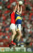 21 July 2002; Willie Morrissey of Tipperary in action against Michael Cronin of Cork during the Bank of Ireland Munster Football Final Replay match between Cork and Tipperary at Páirc Uí Chaoimh in Cork. Photo by Brendan Moran/Sportsfile