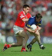 21 July 2002; Willie Morrissey of Tipperary in action against Michael Cronin of Cork during the Bank of Ireland Munster Football Final Replay match between Cork and Tipperary at Páirc Uí Chaoimh in Cork. Photo by Brendan Moran/Sportsfile