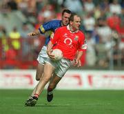 21 July 2002; Ronan McCarthy of Cork in action against Benny Hickey of Tipperary during the Bank of Ireland Munster Football Final Replay match between Cork and Tipperary at Páirc Uí Chaoimh in Cork. Photo by Brendan Moran/Sportsfile