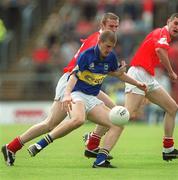 21 July 2002; Kevin Mulryan of Tipperary in action against Nicholas Murphy, left, and Maurice McCarthy of Cork during the Bank of Ireland Munster Football Final Replay match between Cork and Tipperary at Páirc Uí Chaoimh in Cork. Photo by Brendan Moran/Sportsfile