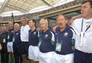 1 June 2002;  Republic of Ireland's managment and staff, left to right, Tony Hickey, security, Mick McMcCarthy, manager, Mick Byrne, physio, Ian Evans, assistant manager, Ciaran Murray, chartered physio, Johhny Fallon, umbro, Joe Walsh, equipment officer and Packie Bonner, goalkeeping coach, stand for the national anthem before the start of the FIFA World Cup 2002 Group E match between Republic of Ireland and Cameroon at Big Swan Stadium in Niigata, Japan. Photo by David Maher/Sportsfile